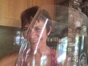 Jane behind a wine glass.